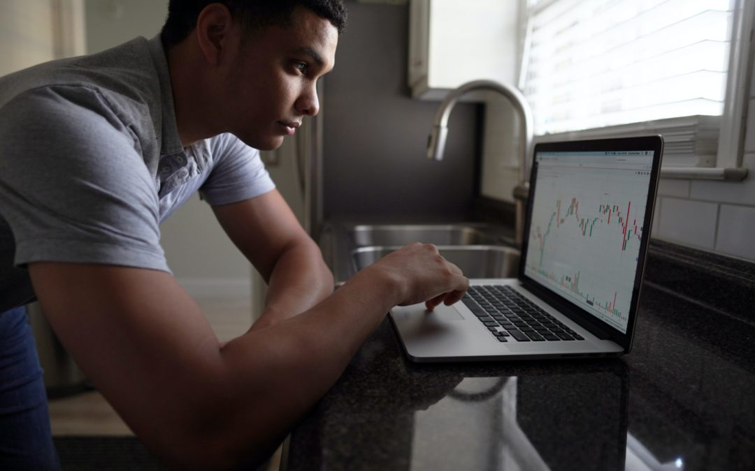 A man working at a laptop.