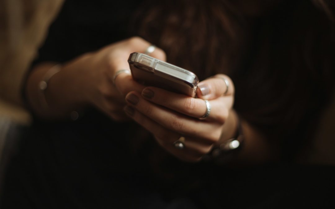 Hands holding a smart phone.